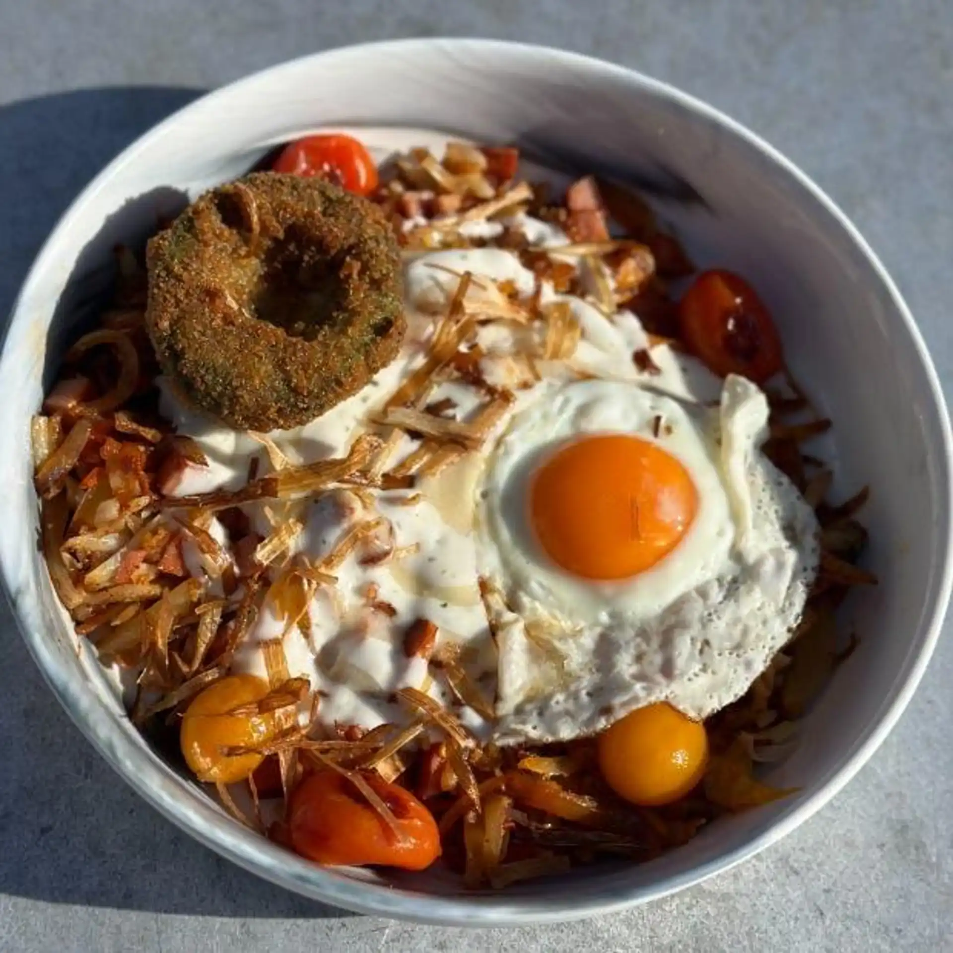 Hash bowl with fried egg and crispy onions at Hash House