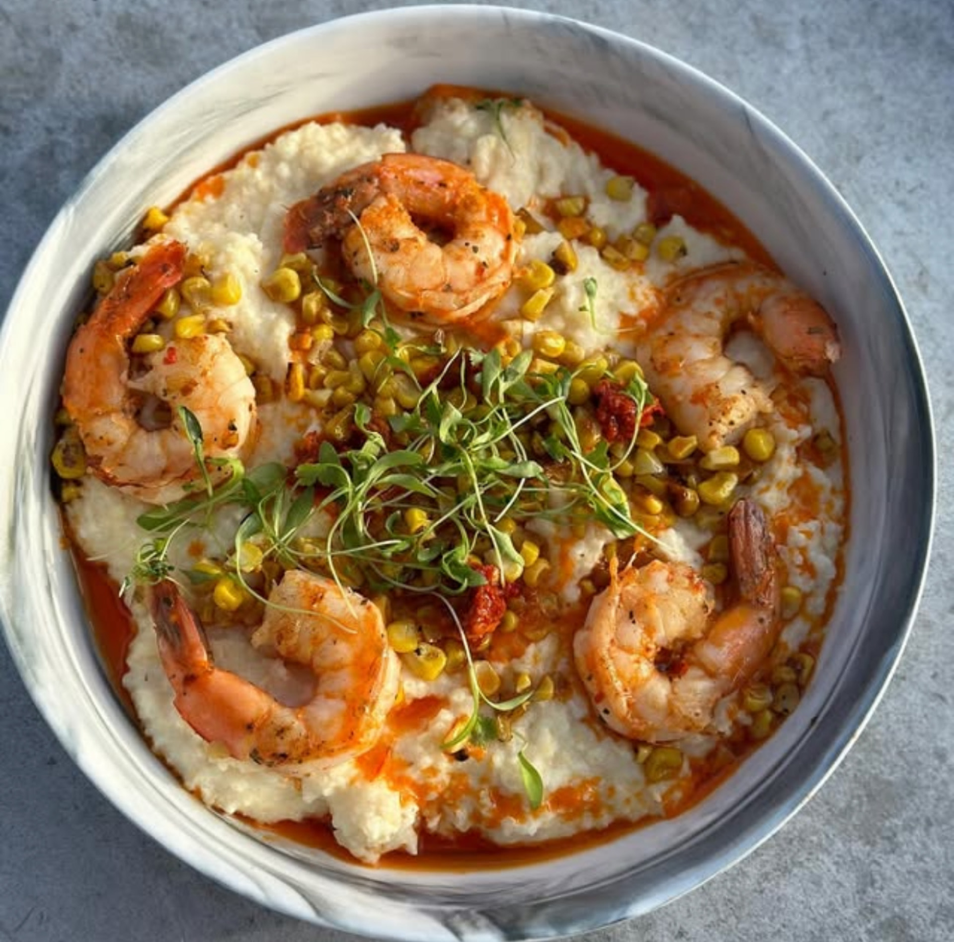Shrimp and grits with sweet corn and microgreens at Hash House