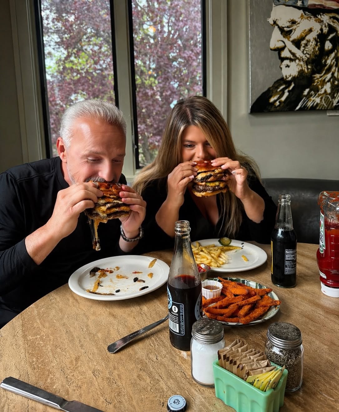 Guests enjoying burgers and sweet potato fries at Hash House