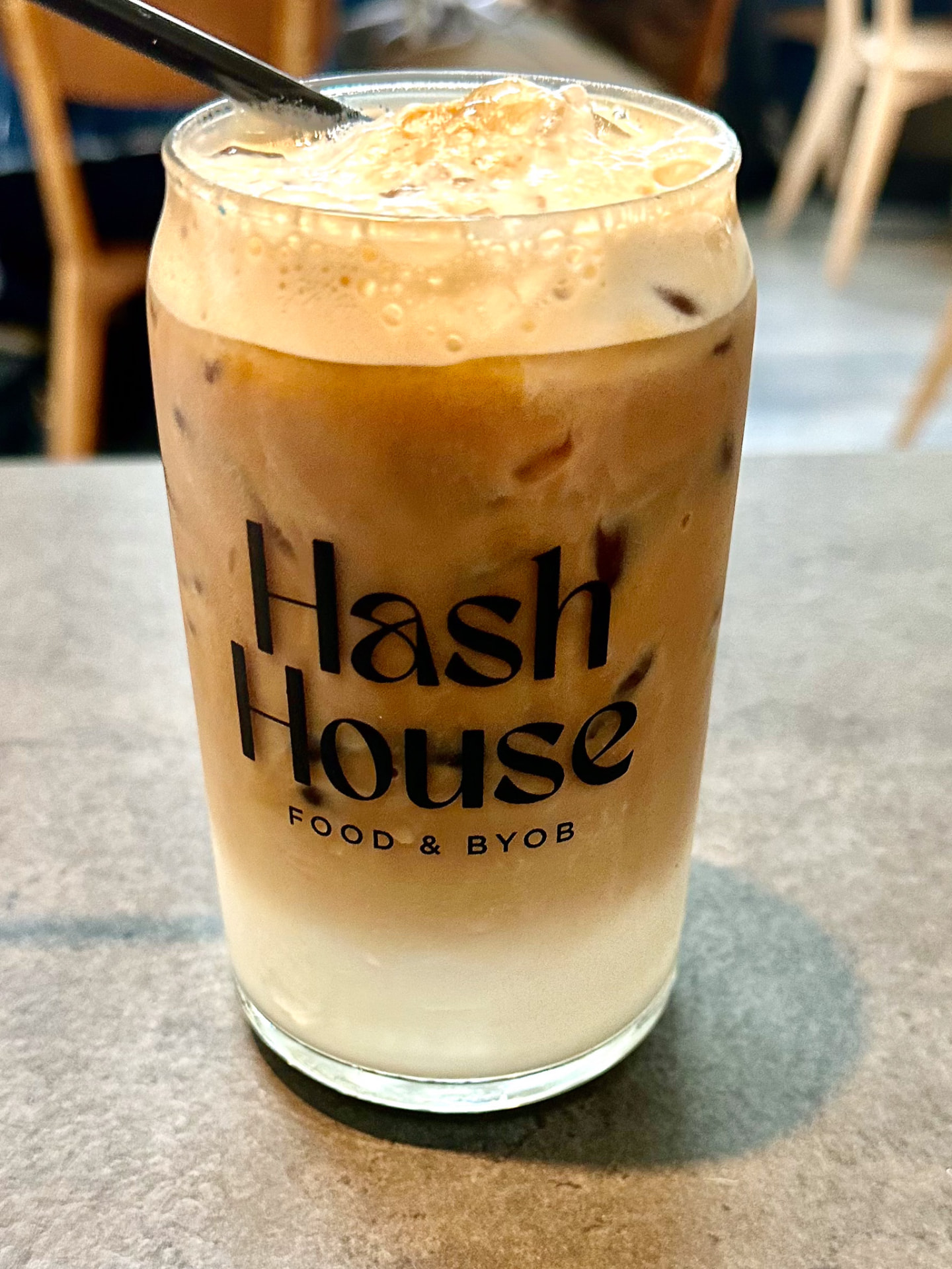 Iced coffee in a Hash House glass with milk and ice at Hash House