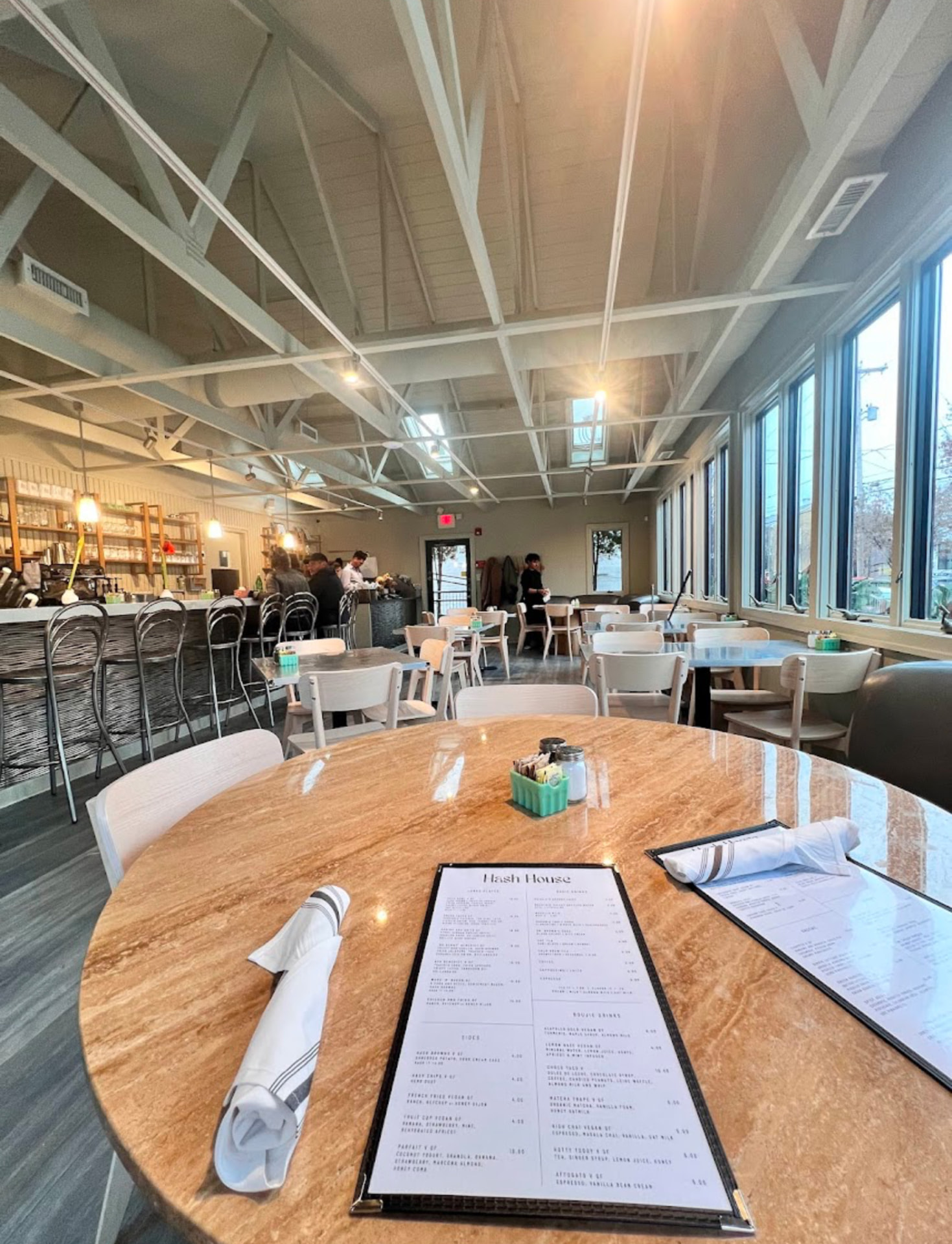 Dining room table with Hash House menus in the bright, vaulted-ceiling dining room