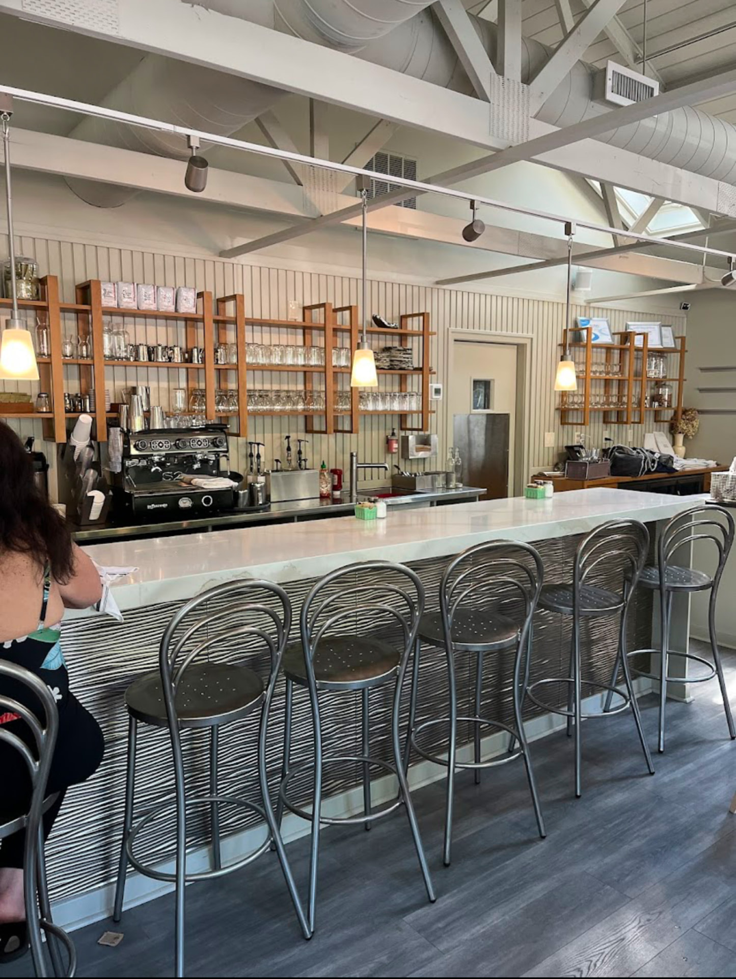 Counter bar seating with bentwood stools and pendant lights at Hash House