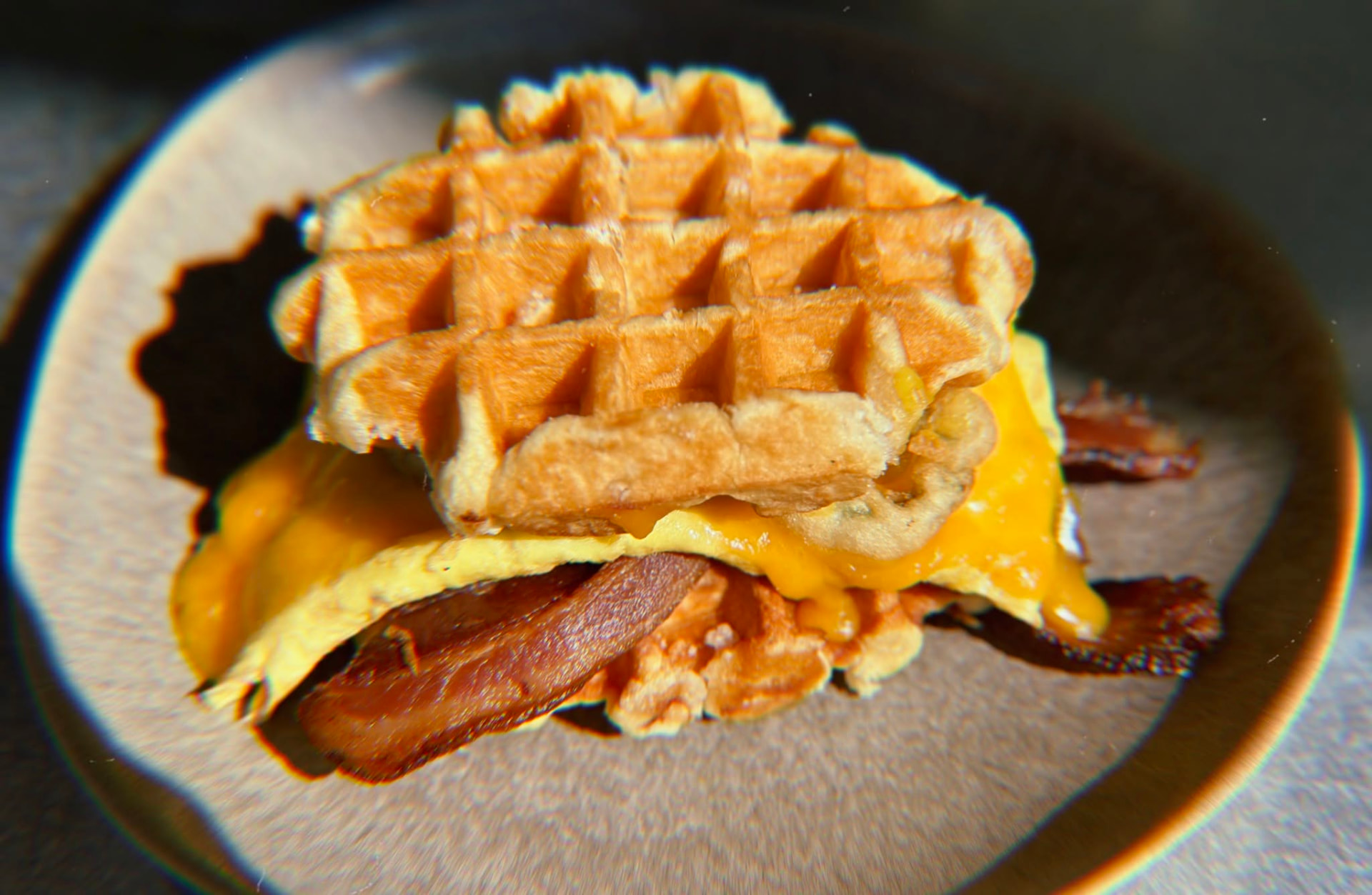 Waffle breakfast sandwich with egg, cheese and bacon at Hash House