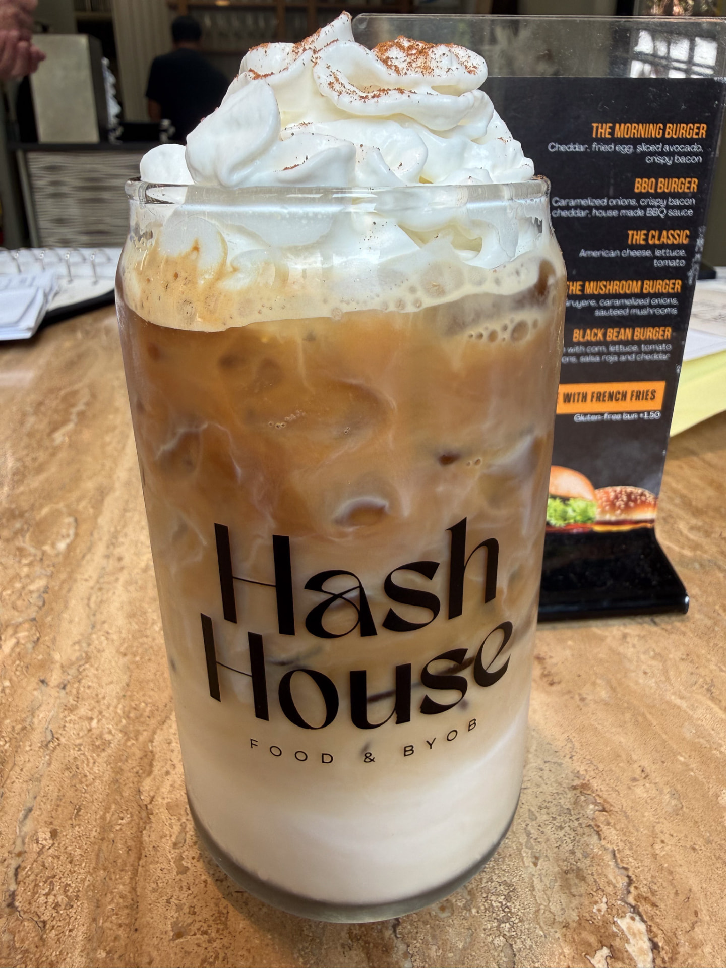 Iced cappuccino with whipped cream in a Hash House glass at Hash House