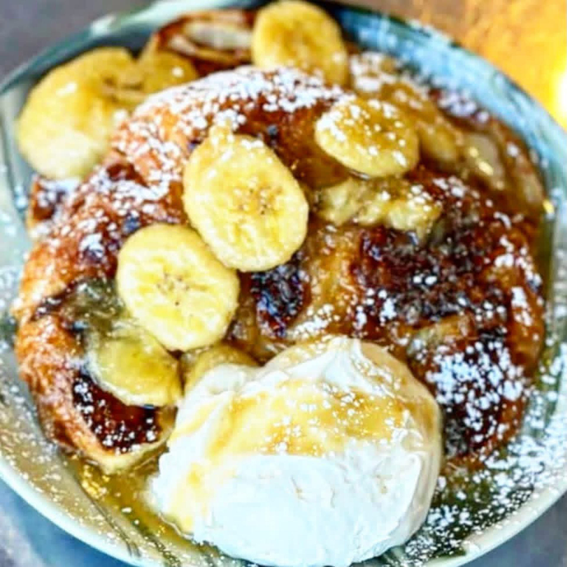 Banana chocolate chip pancakes topped with powdered sugar and cream at Hash House